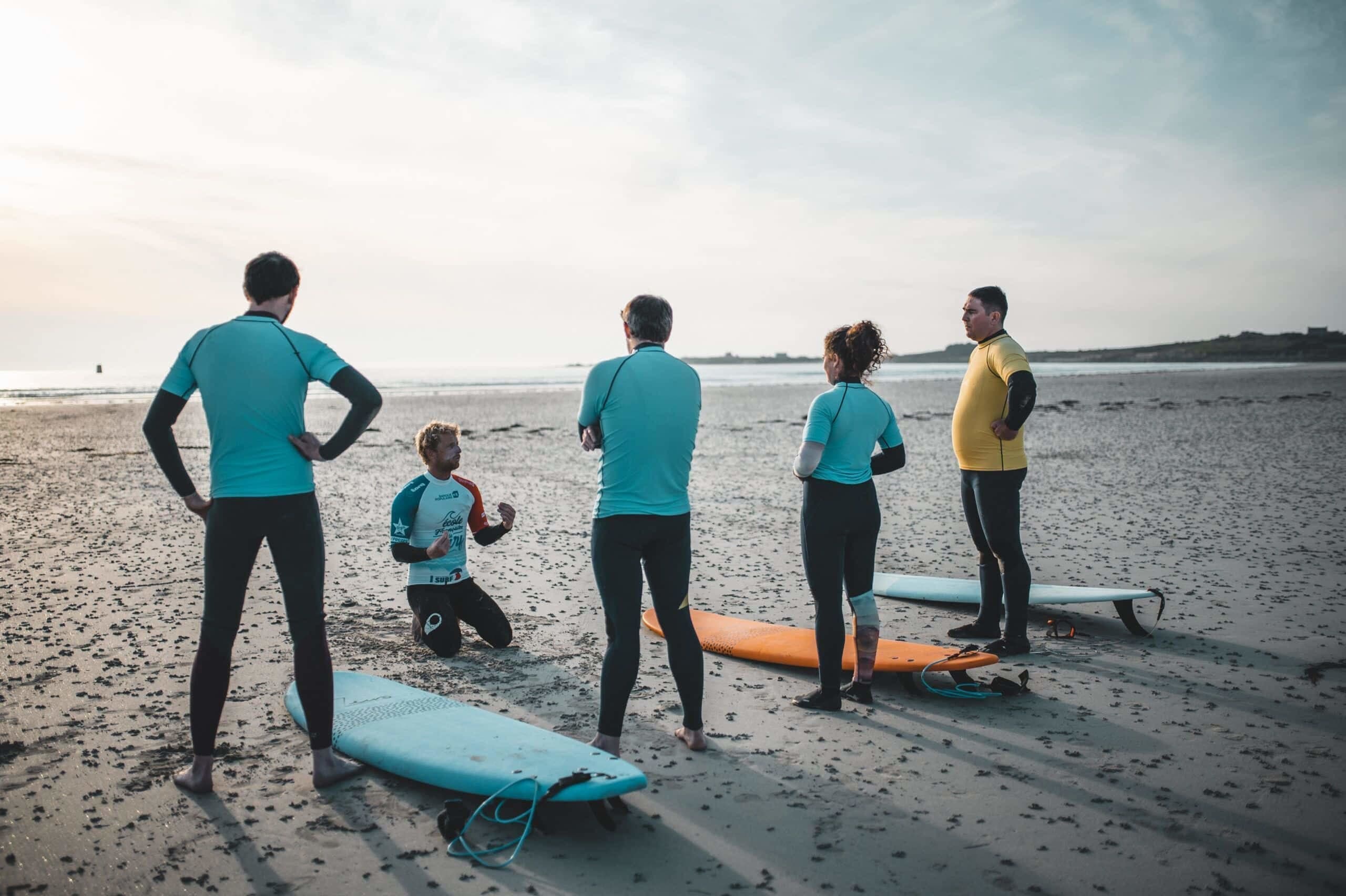 Pierre, moniteur à la Dossen Surf School à Santec explique les bases à des débutants